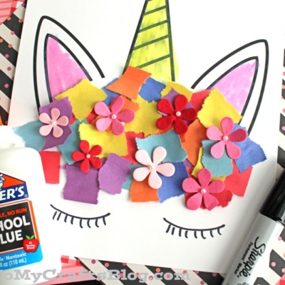 A torn paper unicorn drawing adorned with flowers and a touch of glue for added texture.