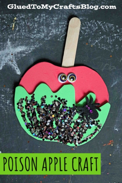A foam craft shaped like a red apple with green dripping poison, a wooden stick, googly eyes, black glitter, and a spider. Perfect for making caramel apple friends! Text reads POISON APPLE CRAFT and GluedToMyCraftsBlog.com.