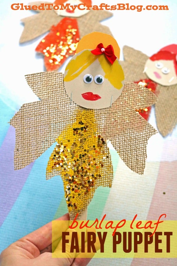 A handmade Autumn Leaf Fairy Puppet crafted by children, featuring colorful fall leaves, a small fairy figurine, and a wooden stick handle.