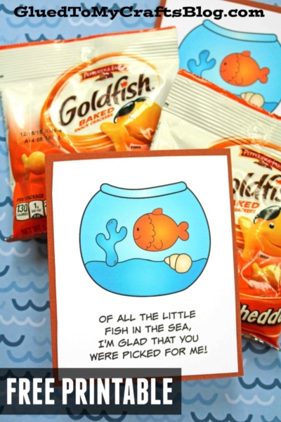 Packets of Goldfish crackers surround a card with a cartoon fish in a bowl and the sweet message, “Of all the little fish in the sea, I’m glad that you were picked for me!” The image advertises a free goldfish snack printable.