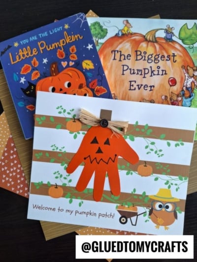 Three pumpkin-themed childrens books and a handmade card with an orange handprint jack-o-lantern, pumpkin decorations, and an owl. Text reads: Welcome to my pumpkin patch! Perfect for celebrating the season, this set brings a warm “welcome to my pumpkin patch” feeling to your fall crafts. Tag: @GLUEDTOMYCRAFTS.