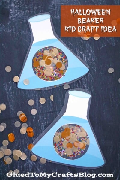 Two beaker kid craft creations filled with colorful sequins and confetti are displayed on a dark background. Loose sequins surround the halloween beaker crafts. The text reads “Halloween Beaker Kid Craft Idea” and “GluedToMyCraftsBlog.com.”.