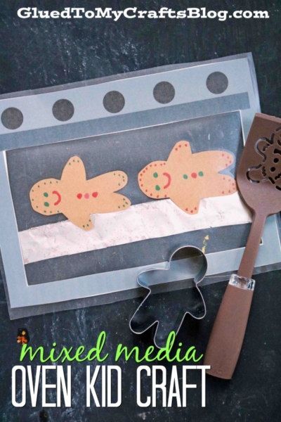A kid’s christmas oven craft features two paper gingerbread cookies on a pretend oven made from construction paper, with a spatula and a gingerbread man cookie cutter beside it. Text reads “mixed media OVEN KID CRAFT.”.