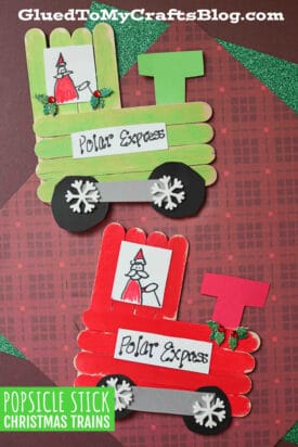 Two handmade popsicle stick Christmas trains, decorated as the Polar Express with wheels, snowflake details, and Santa drawings. One train is green and the other red, both set on festive backgrounds—perfect holiday crafts!.