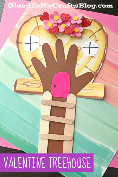 A hand-shaped paper cutout forms a tree trunk with a pink paper bird, popsicle-stick ladder, and a heart-shaped treehouse decorated with flowers and hearts—an adorable paper valentine tree house. Text reads VALENTINE TREEHOUSE.