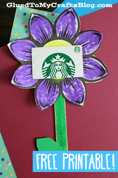 A handmade purple flower gift card craft displays a Starbucks gift card in its center. The background features colorful paper, and text reads, GluedToMyCraftsBlog.com and FREE PRINTABLE!.
