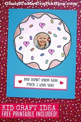 A handmade card features a donut love frame with colorful sprinkles and a child's smiling photo at the center. Below it, text reads “You donut know how much I love you!” on a blue and red polka dot background.