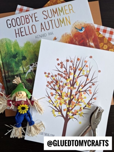 A flat lay featuring Goodbye Summer, Hello Autumn, a fall tree craft with paper punch confetti dots, a small scarecrow figurine, an envelope, and @GLUEDTOMYCRAFTS at the bottom.