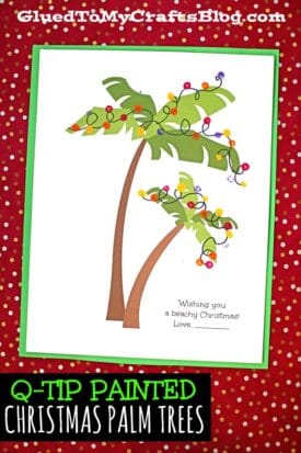 A holiday card with two illustrated, painted Christmas palm trees decorated with colorful lights. The card says, Wishing you a beachy Christmas! Love. The red background features white dots and the bottom reads Q-tip Painted Christmas Palm Trees.