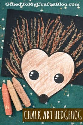 A chalk art hedgehog craft features a brown, heart-shaped paper body with chalk-drawn spines on black paper. Three pastel chalks—orange, tan, and cream—rest on the left. Text reads “CHALK ART HEDGEHOG.”.