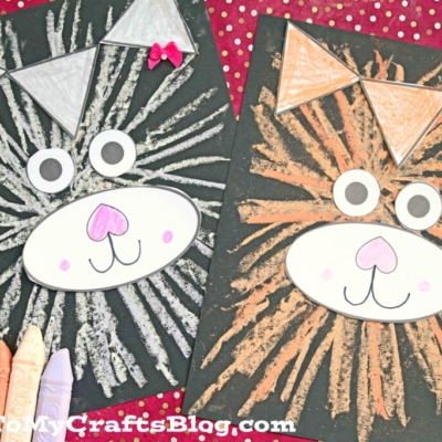 Two lion face crafts, created in chalk art cat style, feature colored chalk lines on black paper with oval snouts, googly eyes, and triangle ears. Crayons are on the side, set against a red background with small white dots.