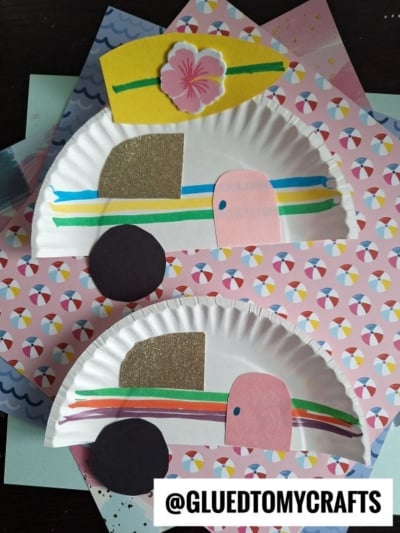 Two paper plate camper crafts resembling retro campers, decorated with colored paper shapes and glitter paper for details, placed on patterned scrapbook paper backgrounds. @GLUEDTOMYCRAFTS is written at the bottom.
