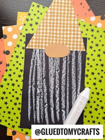 A squid craft made from patterned paper and white paint sits on top of colorful polka dot and star papers, alongside a whimsical chalk art fall gnome for added seasonal charm. A glue pen is placed nearby. @GLUEDTOMYCRAFTS is written at the bottom.
