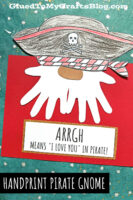A handmade pirate handprint craft features a paper pirate hat, red and white scarf, and a white handprint beard on a red background. Text reads: “ARRGH means ‘I love you’ in pirate!” and “Handprint Pirate Gnome.”.