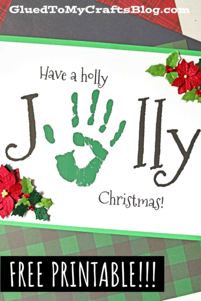 A Christmas card reads “Have a holly Jolly Christmas!” with the “O” in Jolly replaced by a green handprint, making it a charming handprint jolly keepsake, decorated with holly and poinsettia. Text at bottom says “Free Printable!!!”.