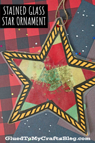 A stained glass Christmas star shaped object adorned with shimmering gold glitter.