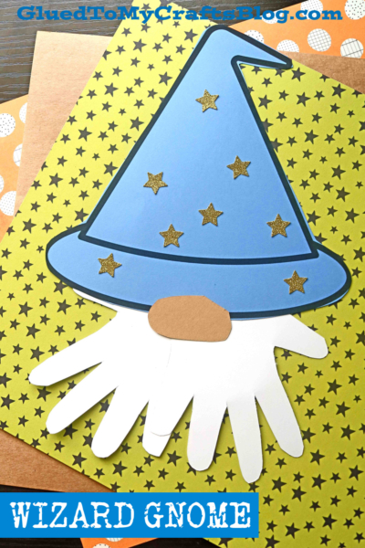 A handprint wizard gnome paper craft features a blue hat with gold stars and a white handprint beard, set on yellow star-patterned paper. "WIZARD GNOME" is written at the bottom.