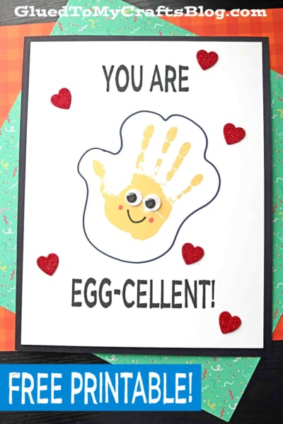 A craft project featuring a handprint egg designed to look like a yellow egg with googly eyes and a smile, surrounded by red glitter hearts. The text says You are egg-cellent! Free printable—perfect as a handprint egg keepsake!.