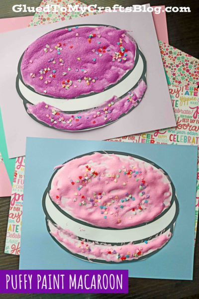 A group of finished macaroon paper craft designs, using puffy paint and loose craft glitter on top.