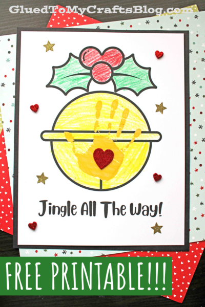 A handprint Christmas bell craft features a colored jingle bell with a yellow handprint in the center, glitter hearts and stars, “Jingle All The Way!” below, and “FREE PRINTABLE!!!” at the bottom.