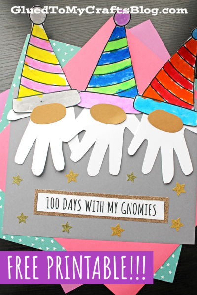 Three colorful paper gnome crafts with handprint beards and striped hats are displayed on layered pastel papers—a perfect 100 days craft idea! Text reads 100 days with my gnomies and FREE PRINTABLE!!! Gold stars decorate the background.