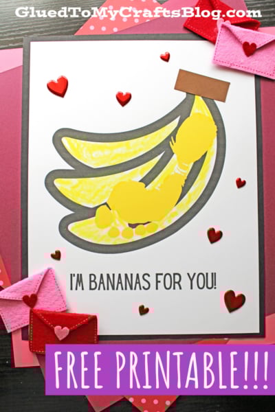 A handmade card featuring yellow bananas, red heart stickers, and the text IM BANANAS FOR YOU! on a white background. Inspired by a Footprint Banana Keepsake, the card rests on pink and red paper with felt heart decorations. FREE PRINTABLE!!!.