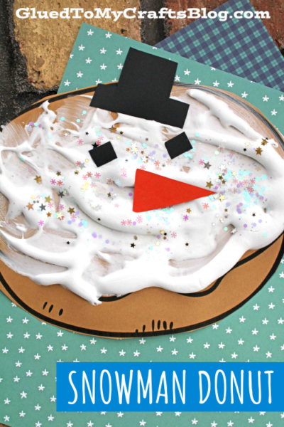 A puffy paint snowman made out of white frosting and paper cutouts, resembling a cute donut.
