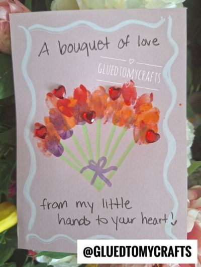 A handmade card features a bouquet made with colorful painted fingerprints and red heart gems, green stems, and a purple bow—perfect inspiration for flower kids crafts. Text reads: A bouquet of love from my little hands to your heart!.