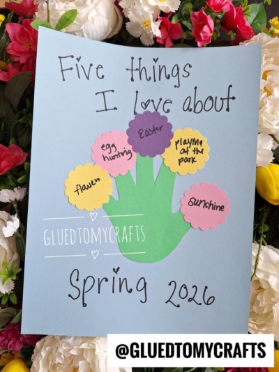 A fun flower kids crafts project with blue paper, a green handprint, and five colorful flower shapes listing flower, egg hunting, Easter, playing at the park, and sunshine. Text reads Five things I love about Spring 2026.