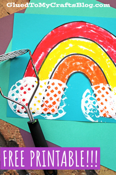 A colorful potato masher rainbow craft with white clouds, created using paint, is displayed on a blue background. Text reads GluedToMyCraftsBlog.com and FREE PRINTABLE!!! in bold letters.