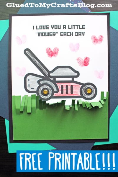A handmade mower card craft features a drawing of a lawnmower with pink heart stamps above it and the text “I love you a little mower each day.” Green paper fringe at the bottom resembles grass. A banner says “Free Printable!”.