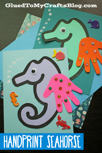 Two colorful handprint seahorse crafts with googly eyes, each featuring a handprint cutout fin and small foam sea creature stickers. “Handprint Seahorse” is displayed at the bottom.