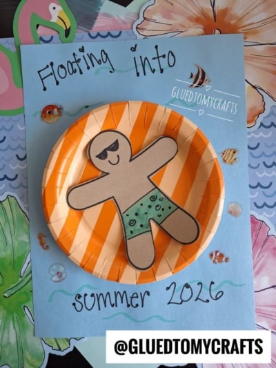 A paper craft features a smiling figure in green swim trunks lounging on a pool floatie art plate, with the text “Floating into summer 2026” on a blue background decorated with tropical cutouts. @GLUETOMYCRAFTS is at the bottom.