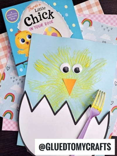 A children’s book titled There’s a Little Chick in Your Book, plus a cute fork painting crafts chick with googly eyes, an eggshell cutout, and rainbow-themed scrapbook paper underneath. @GLUEDTOMYCRAFTS is at the bottom.