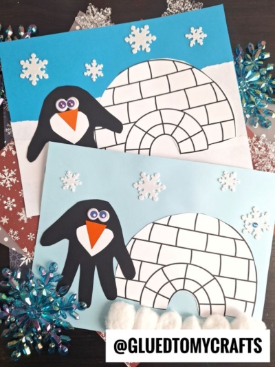 Two winter-themed crafts featuring a handprint penguin and an igloo made of paper on blue backgrounds, decorated with paper snowflakes and cotton ball snow. The adorable handprint penguin adds extra charm. @GLUEDTOMYCRAFTS is written at the bottom.