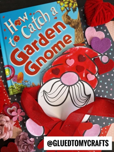 A colorful book titled How to Catch a Garden Gnome is surrounded by heart-shaped decorations, a gnome handprint hug craft with red and pink hearts, and a tag reading @GLUEDTOMYCRAFTS on the bottom.