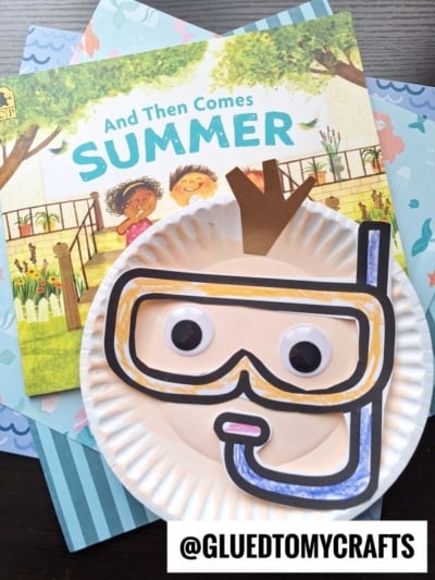 A children’s book titled And Then Comes Summer sits under a playful paper plate snorkel craft with big googly eyes and a hand-drawn mask, suggesting a fun summer activity. @GLUETOMYCRAFTS is at the bottom.