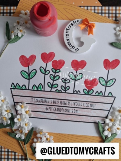 A Grandparents Day craft featuring red heart-shaped flowers in a pot, a paint bottle, faux flowers, a GLUEDTOMYCRAFTS horseshoe charm, and the heartfelt message: If grandparents were flowers I would pick you! This sweet fingerprint flower card is the perfect keepsake to show your love and creativity.