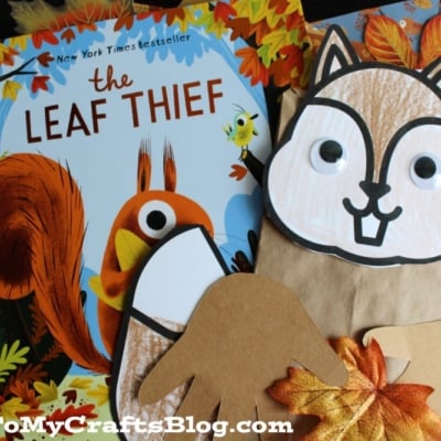 A children's craft project features a paper bag squirrel with googly eyes and handprint-shaped cutouts holding paper leaves.