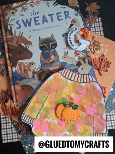 Children’s book The Sweater with autumn-themed crafts, including a painted paper sweater with a pumpkin, faux leaves, and a tag that reads @GLUEDTOMYCRAFTS on a plaid background. The collection also features a fun pom pom stamped fall sweater activity, perfect for little hands to explore seasonal creativity.