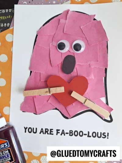 A torn paper ghost craft made of pink paper pieces with googly eyes, a paper heart, and clothespins on white paper. Below, it says YOU ARE FA-BOO-LOUS! and @GLUEDTOMYCRAFTS on a label.