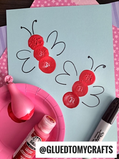 USE A SLIGHTLY BLOWN UP BALLOON TO "STAMP" LOVE BUGS ON PAPER