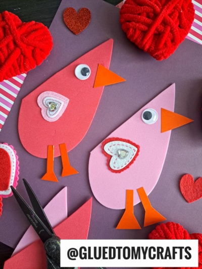 CUT CRAFT FOAM HEART SHAPES IN HALF TO MAKE LOVE BIRDS
