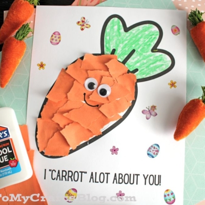 A children’s craft features a Torn Paper Carrot with orange paper pieces, green crayon leaves, and googly eyes on white paper. Text reads I CARROT ALOT ABOUT YOU! Decorative stickers and glue complete this fun project.