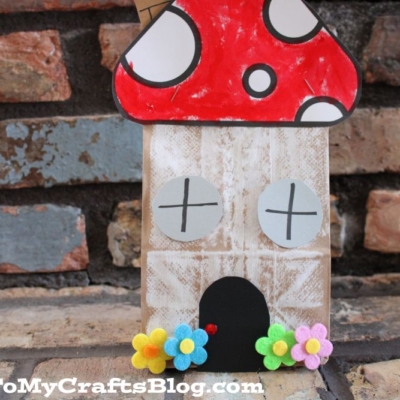 A whimsical paper bag mushroom house, crafted to resemble a charming cottage, brings fairytale magic to any setting.