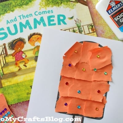 A summer-themed craft featuring a torn paper popsicle decorated with colorful gems on a "HAPPY SUMMER!" sheet. Elmers glue, gems, and orange paper scraps are beside it.