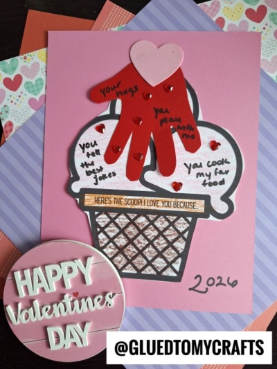 A handmade Valentine’s card shaped like an ice cream sundae doubles as a charming ice cream keepsake, with red gloves for toppings, heart gems, and sweet notes. It reads “HAPPY Valentine’s DAY” beside it and “@GLUEDTOMYCRAFTS” at the bottom.