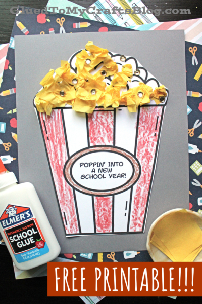 A back to school popcorn craft features a popcorn bucket with yellow tissue paper popcorn pieces, decorated and labeled Poppin Into a New School Year! Glue, a cup, and printed paper are nearby. Text reads FREE PRINTABLE!!!.