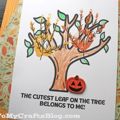 A children’s craft project featuring a printable tree with colorful handprint leaves and a small orange pumpkin cutout. This cutest leaf keepsake reads: THE CUTEST LEAF ON THE TREE BELONGS TO ME!