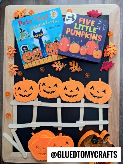 A Halloween-themed flat lay featuring Pete the Cat: Five Little Pumpkins and Five Little Pumpkins books, felt pumpkin decorations, popsicle stick crafts, autumn leaves, fall themed sensory bin ideas, and a @GLUEDTOMYCRAFTS label.